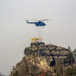 Ein Hubschrauber bringt Bestandteile des neuen Pavillons zum Gipfel des Marienfelsens bei Jetřichovice (Dittersbach).