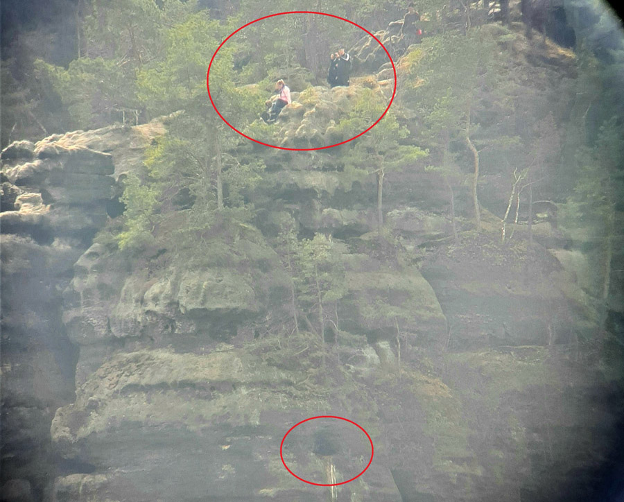 Durchs Fernrohr beobachtet: Mehrere Menschen nur wenige Meter über dem besetzten Wanderfalken-Nest und inmitten der ausgeschilderten Horstschuzzone, 11. April 2021.
